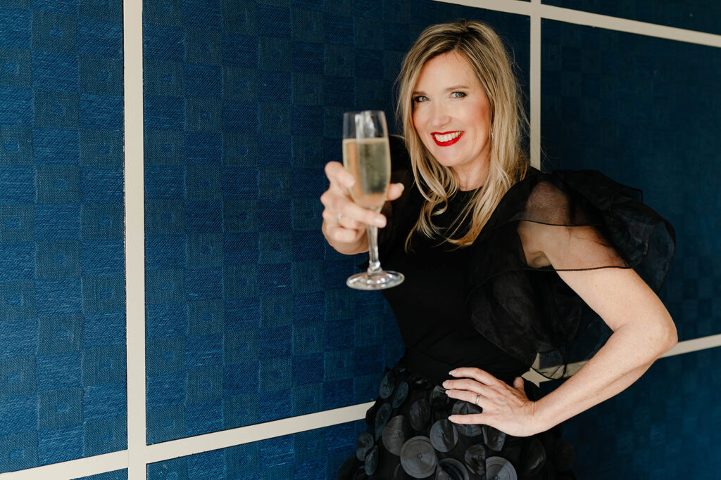 Yvonne Dam raising a glass of champagne